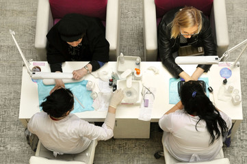 April 20, 2019: Moscow, Russia - manicure masters at work. Top view