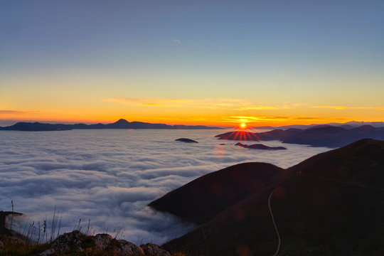 Italy, Marche, Apennines, Mount San Vicino at sunrise seen from mount Cucco