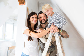 Portrait of happy family working on loft conversion