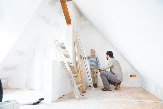 Father and son planning loft conversion