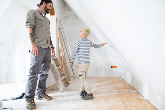 Father and son planning loft conversion