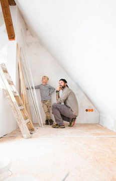 Father and son planning loft conversion