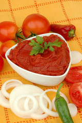 Delicious pasta with ingredients for cooking on an orange background