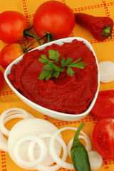 Delicious pasta with ingredients for cooking on an orange background