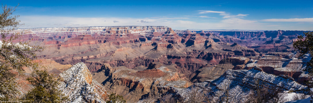 A panorama of the Grand Canyon in winter with snow in the higher elevations.  This is an epic image taken from the Grand Canyon village in Grand Canyon National Park in Arizona, USA.
