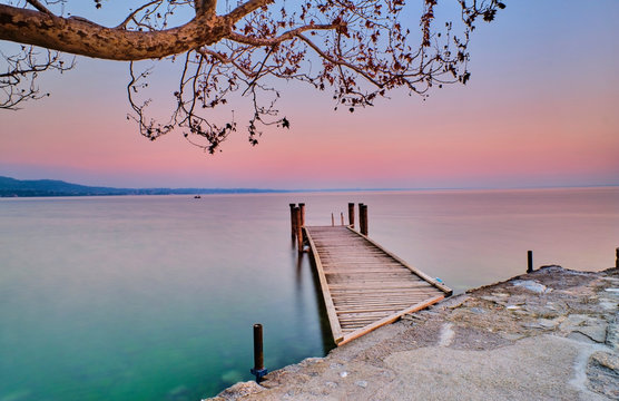 Italy, Punta san Vigilio, Lake Garda, jetty at sunset