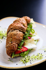 Reform croissant sandwich on a tendy plate. Gourmet conception.