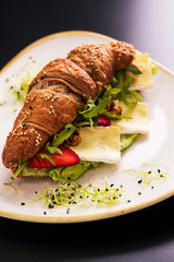 Reform croissant sandwich on a tendy plate. Gourmet conception.