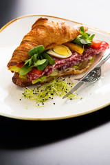 Reform croissant sandwich on a tendy plate. Gourmet conception.