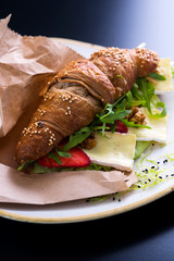 Reform croissant sandwich on a tendy plate. Gourmet conception.
