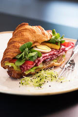 Reform croissant sandwich on a tendy plate. Gourmet conception.