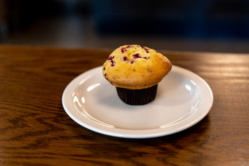 muffins with chocolate topping on table in big caffe