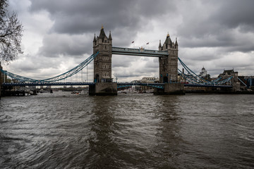 Fototapeta na wymiar Tower Bridge in London, UK. Cloudy day and rain with beautiful dramatic clouds.