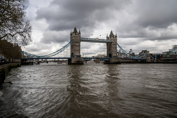 Fototapeta na wymiar Tower Bridge in London, UK. Cloudy day and rain with beautiful dramatic clouds.