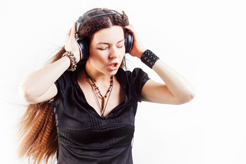 Young stylish woman in large headphones listening to music and having fun.