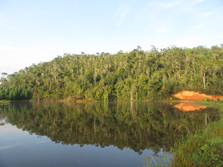 Lake surrounded by low hills covered with natural jungle near Andasibe-Mantadia National Park...