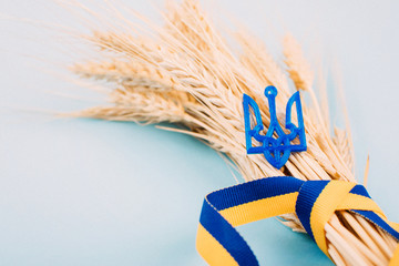 Ukrainian background with national symbols, Coat of arms trident, yellow and blue ribbon, golden wheat spikelets on blue. 2019 Ukrainian presidential election - obrazy, fototapety, plakaty