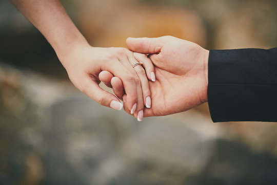 hands of a young couple with a ring. love couple relationship