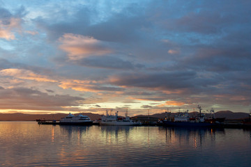 Fototapeta na wymiar Ushuaia harbour (Argentina) with stunning sunset. One of the most southern most cities in the world.