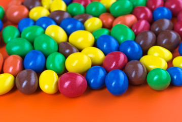 Fototapeta na wymiar Close-up shot of colorful chocolates on colored background