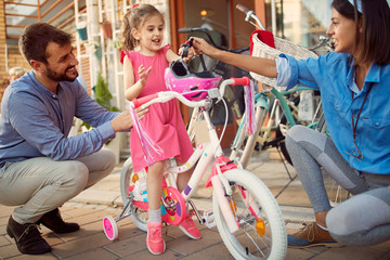 Fototapeta premium father buy daughter new bicycle in bike shop.