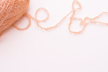 Peach yarn on white background