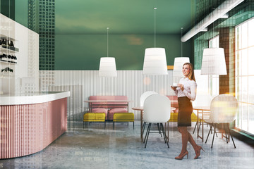 Blonde woman in modern green bar