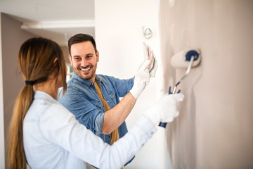 Man and woman renovating apartment.