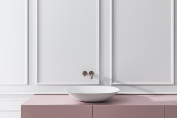 Bathroom sink near white wall