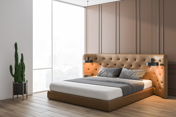 Beige bedroom corner with leather bed
