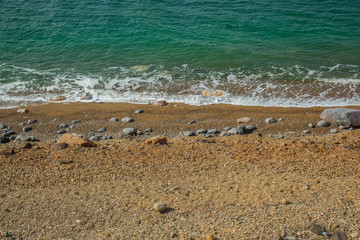 dead sea salty coast line empty beach with sand and stone surface
