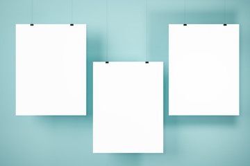 Three mock up posters on blue wall