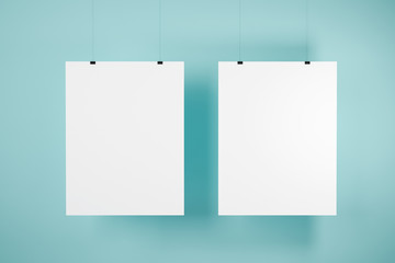 Two mock up posters on blue wall