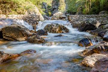 Fototapeta na wymiar Waterfall with stones in wild nature in Fragas de Sao Simao, Figueiro dos Vinhos, Leiria, Portugal.
