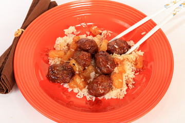 Sweet and Sour Meatballs on Rice with Chopsticks
