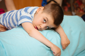 little kid with cerebral palsy has musculoskeletal therapy by doing exercises in body fixing. Load on hands,cheerful boy with disability at rehabilitation center for kids with special needs