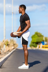 Black african american young man stretching after outdoor jogging
