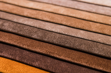Close-up diagonal lines of textile upholstery in samples to select the color and fabric of the furniture. Abstract multicolored background