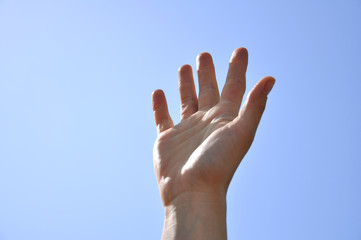 Fototapeta na wymiar right hand raised up in the sky