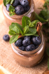 Cake dessert. Chocolate mousse with blueberry, mint and cinnamon