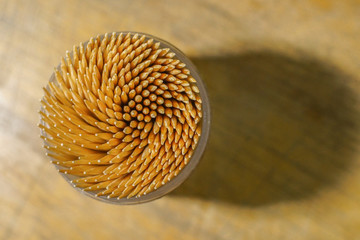 Toothpicks in a box on brown wooden background,select focus.