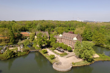 Fototapeta na wymiar Aerial Summer View Water Castle and Public Park Gladbeck Germany 