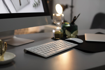Stylish workplace with modern computer on desk, space for text. Focus on keyboard