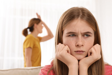 Mother scolding her teenager daughter at home