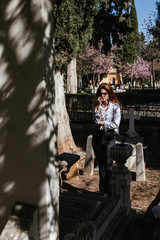 Fototapeta premium Woman crying in the graveyard by a deceased relative