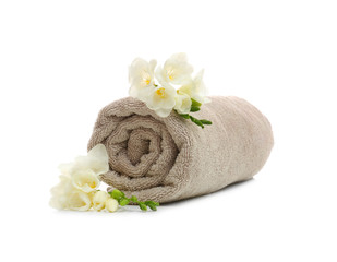 Obraz na płótnie Canvas Clean rolled towel with flowers on white background