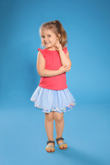 Full length portrait of cute little girl against color background