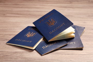 Many Ukrainian internal passports on wooden background