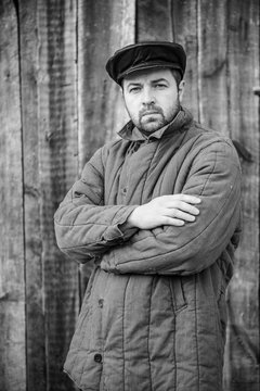 Portrait of old-fashioned man, monochrome. Concept - peasant of 1950s, retro style