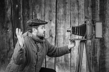 Concept - selfie. Selfie of old fashioned man on large format camera